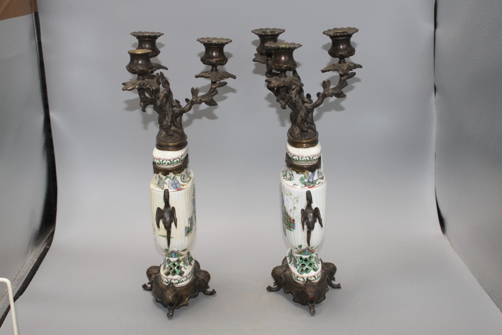 A pair of Samson famille verte style bronze mounted candelabra, with rustic branches and dragon handles, height 41cm
